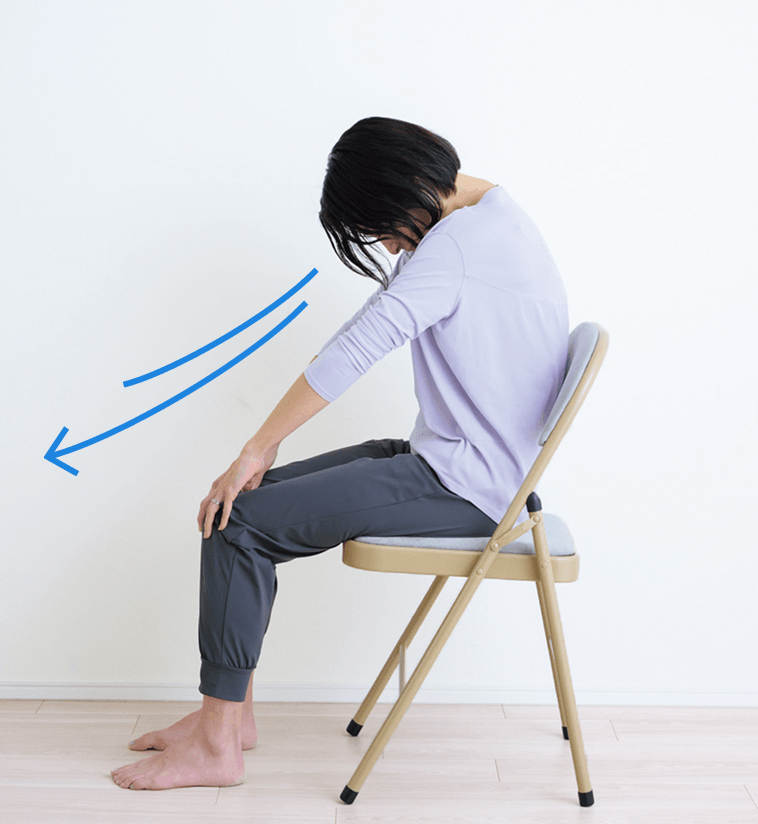 肩の力を抜いて背中を丸め息を吐く先生