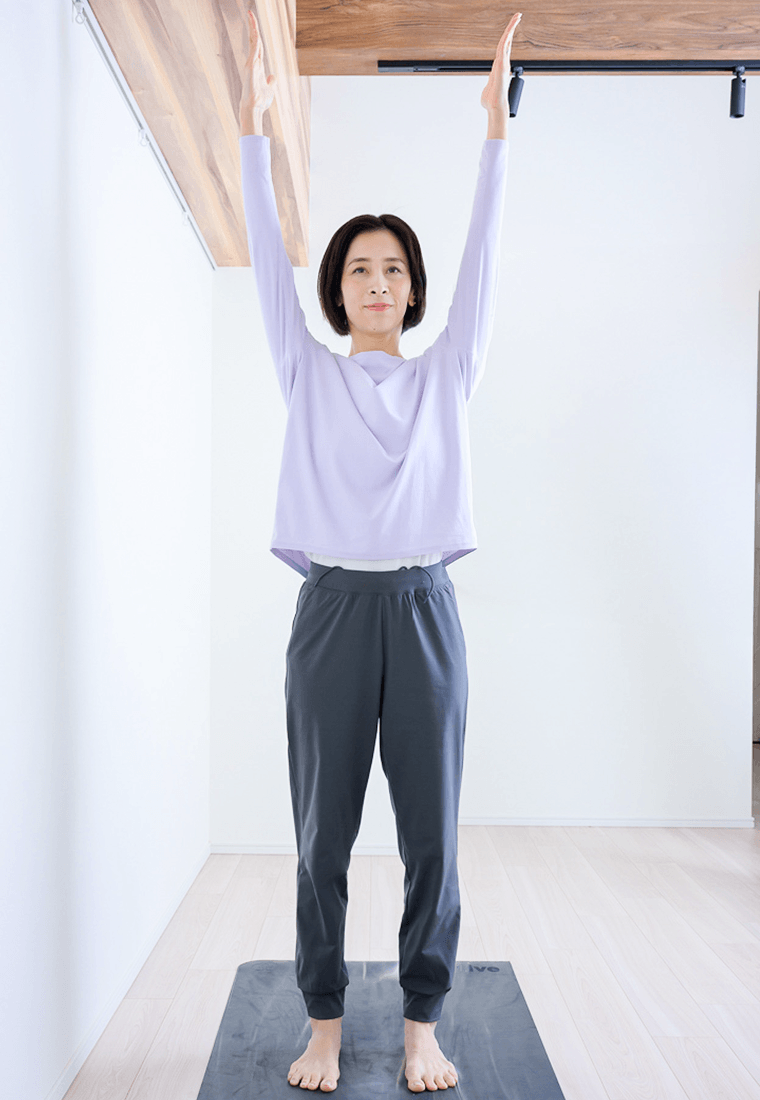 息を吸いながら両手をゆっくり上へ伸ばす先生